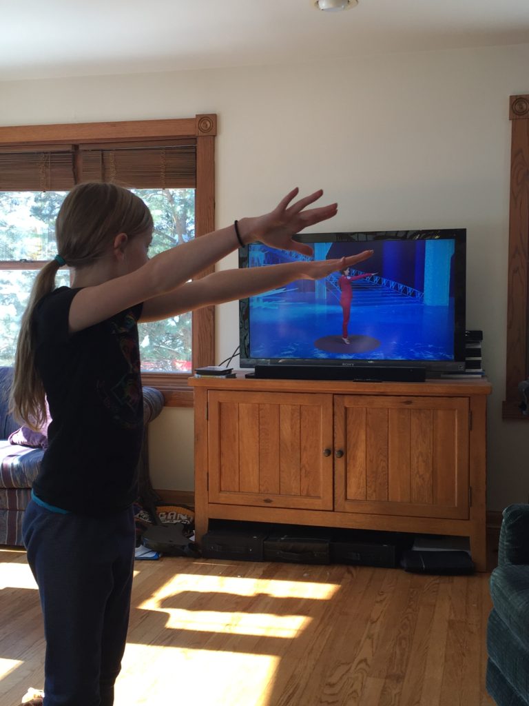 My daughter doing Yoga Kids on YouTubeb