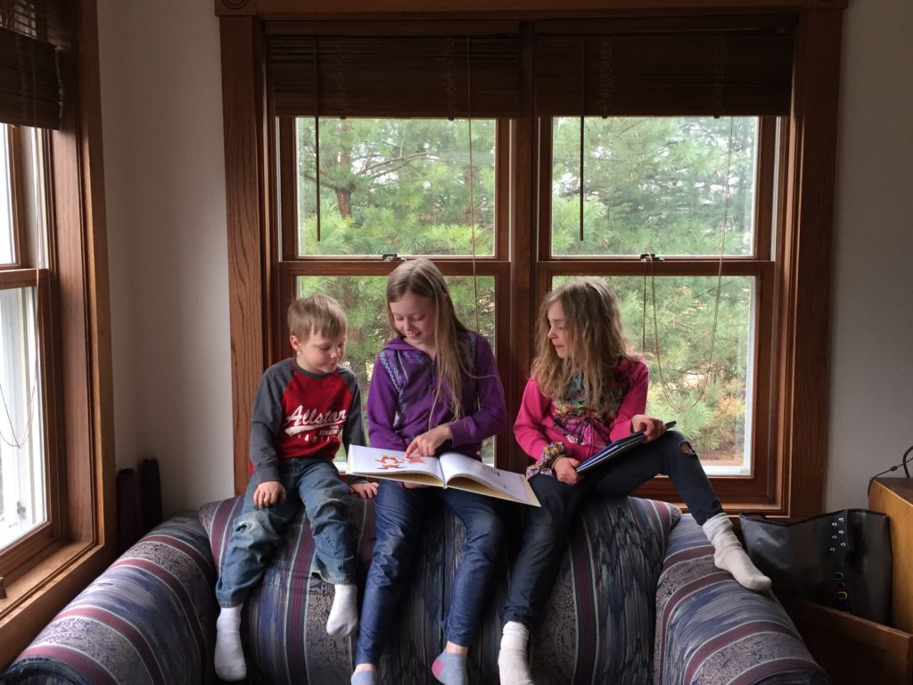 My oldest daughter reading to her younger siblings