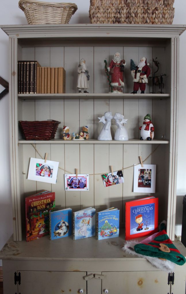 Our living room hutch display for Christmas with our favorite Christmas books