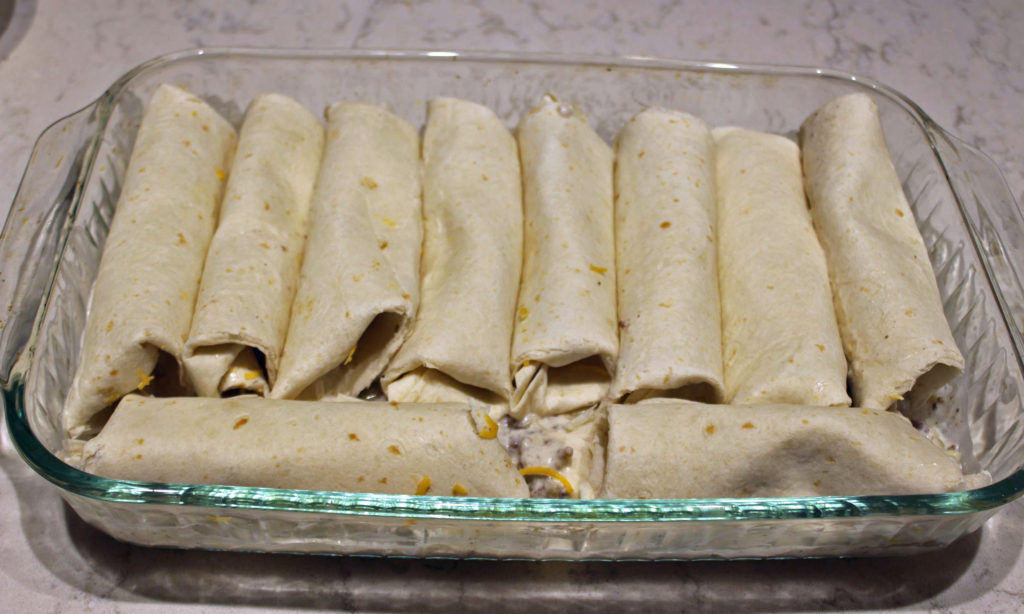 enchiladas laying in the pan
