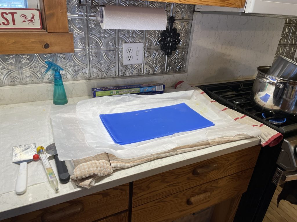 Parchment covered work surface for making your own beeswax sheets using a mold