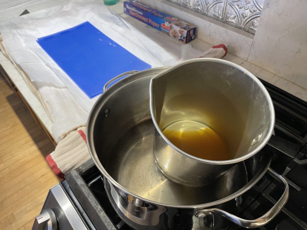 Heat beeswax in a double boiler