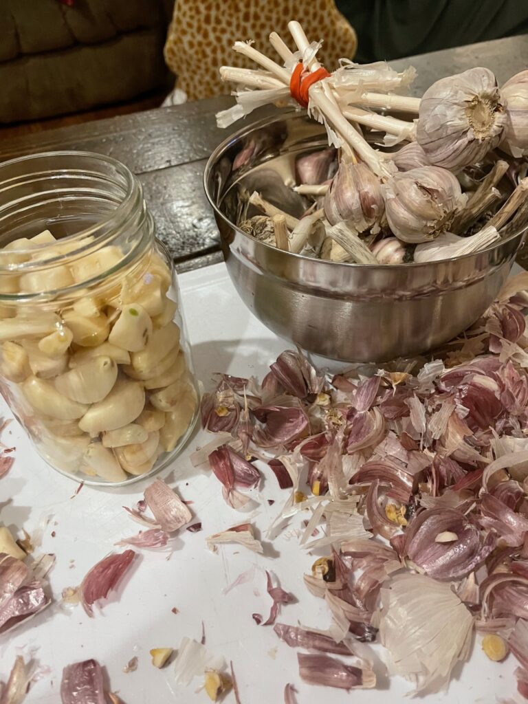 peeled garlic in a jar ready for the the honey