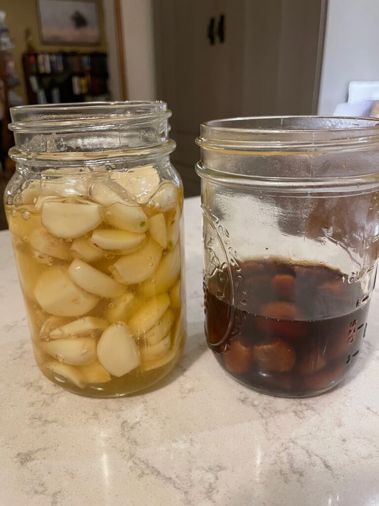 Comparing the color of new honey fermented garlic to the one that has fermented for a year